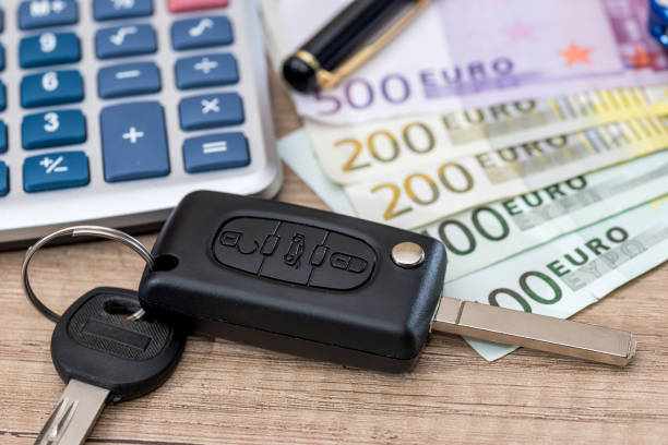istock euro bills with car key and calculator. 696879980