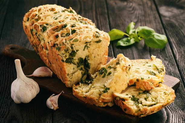 istock Homemade herb bread loaf with garlic and cheese. 696881472