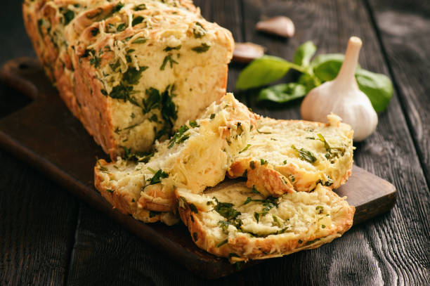 istock Homemade herb bread loaf with garlic and cheese. 696881588