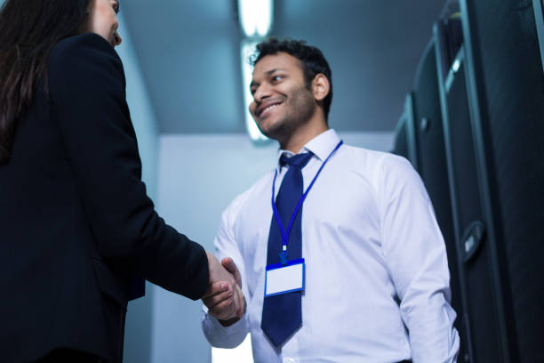 istock Handsome cheerful man greeting his new colleague 696882060