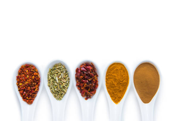 istock Top view of assorted aromatic spices in ceramic spoons isolated on white 696884134