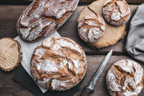 istock Delicious fresh bread on wooden background 696884646