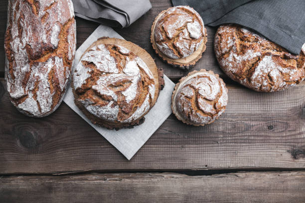 istock Delicious fresh bread on wooden background 696884722