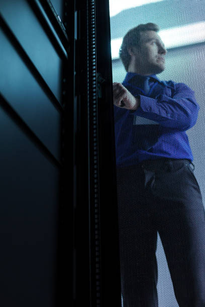 istock Handsome good looking man standing behind the door 696884816