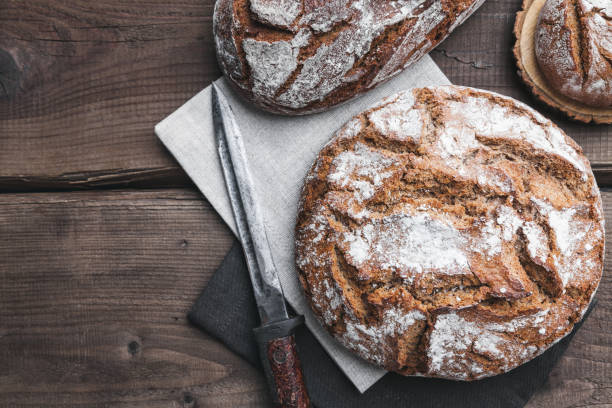 istock Delicious fresh bread on wooden background 696884856