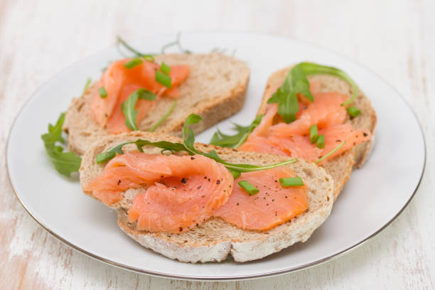 istock sandwich with smoked salmon on white plate on white background 696885342