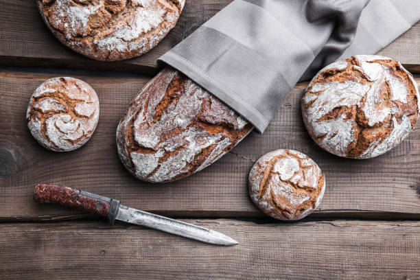 istock Delicious fresh bread on wooden background 696885502