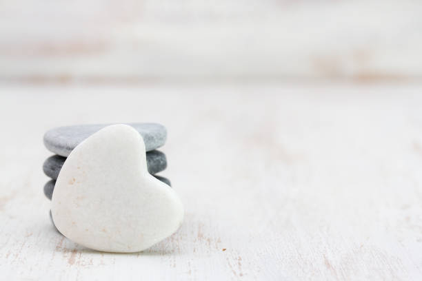 istock decoration stone heart on white wooden background 696889060