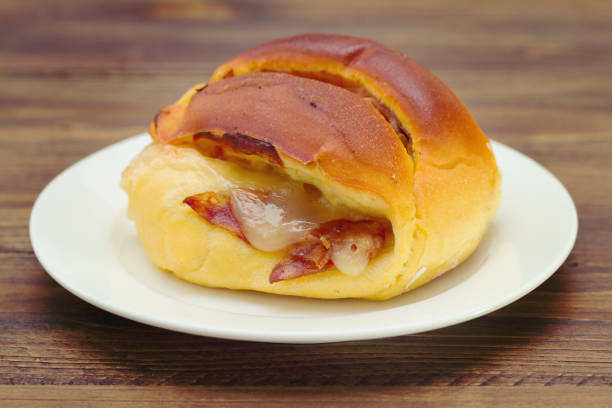 istock bread with cheese and meat on white plate on brown wooden background 696889062