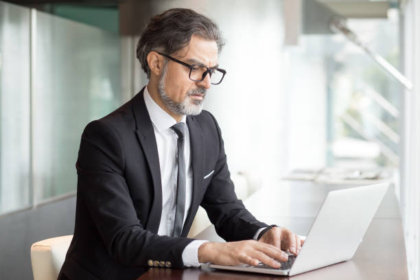 istock Concentrated senior man typing on laptop 696889782