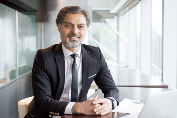 istock Portrait of successful financier at paperwork 696889856