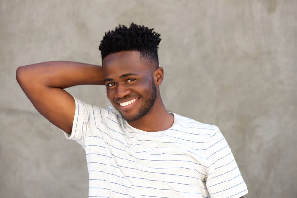 istock smiling african man with hand behind head 696892196