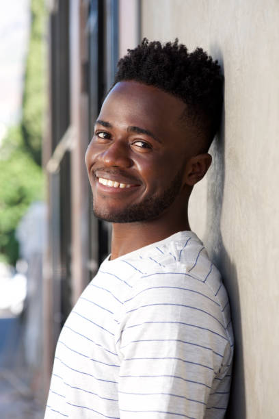 istock smiling african american man leaning against wall 696892242