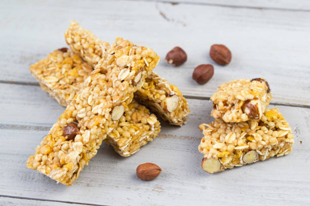 Homemade granola bars with roasted nuts, selective focus, wooden background Homemade granola bars with roasted nuts, selective focus, grey wooden background Power Bar stock pictures, royalty-free photos & images