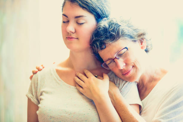 istock Happy mother resting on shoulder of daughter 696897174