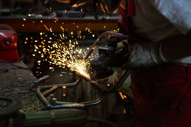 istock Electric wheel grinding on steel structure in a workshop. 696898000
