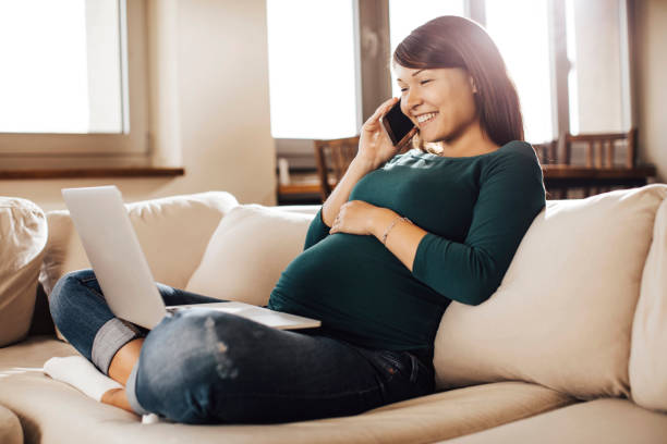 istock Pregnant woman talking on phone 696901698