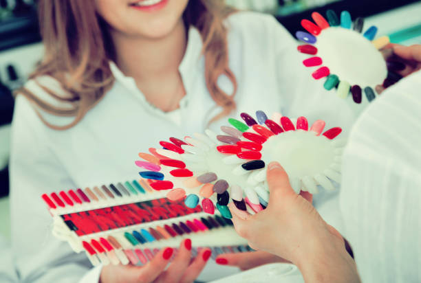 istock Female client doing nails in nail salon in close-up 696901880