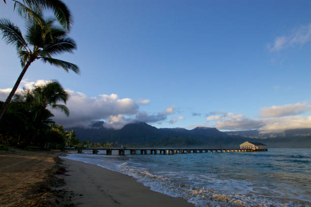 Hanalei, Kauai, USA - September 10, 2011: Late afternoon scene with people and tropical beauty at Hanalei Bay on Kauai.