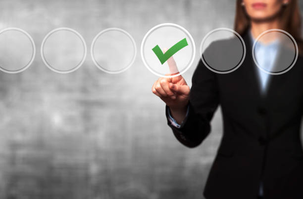 istock Business women  check mark on virtual screen 696905142