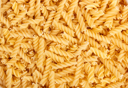 Close up view at the fusili pasta Macaroni background or texture