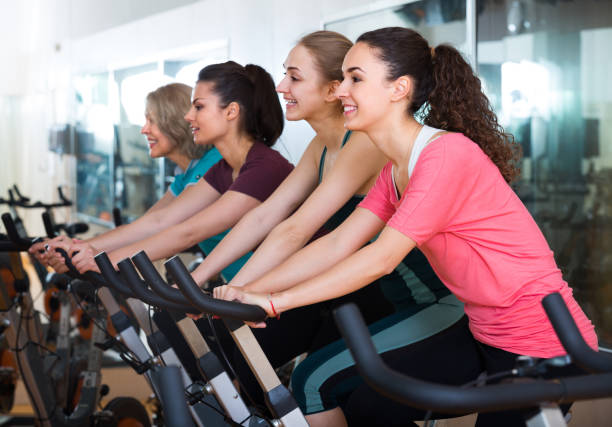 istock Females riding stationary bicycles 696908430