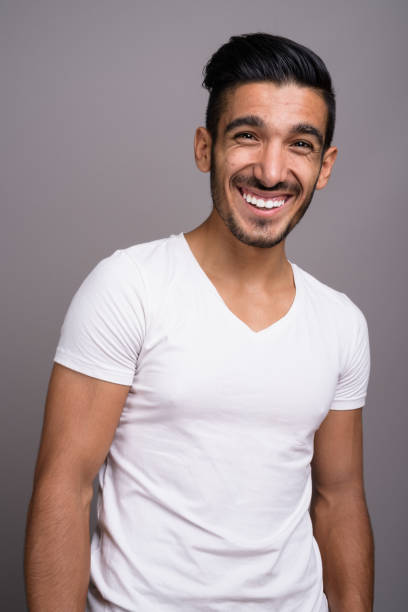 istock Studio shot of young handsome Persian man against gray background 696920176