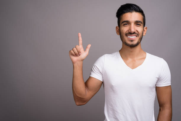 istock Studio shot of young handsome Persian man against gray background 696920362