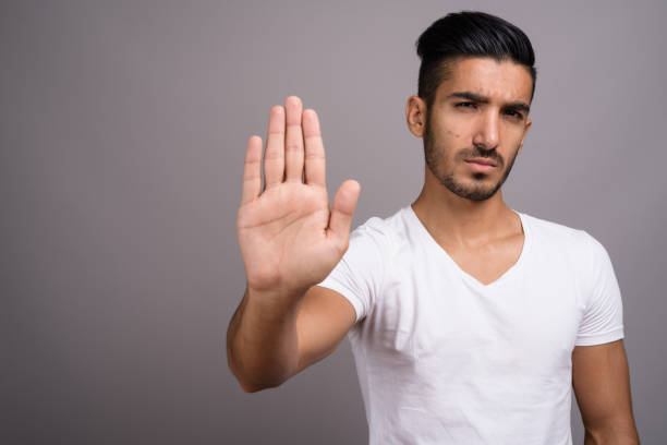 istock Studio shot of young handsome Persian man against gray background 696920488