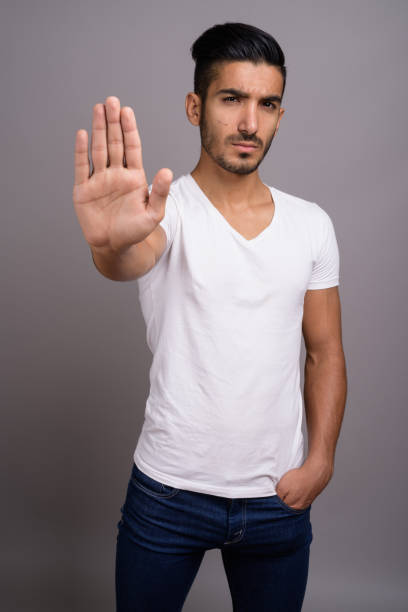 istock Studio shot of young handsome Persian man against gray background 696920508
