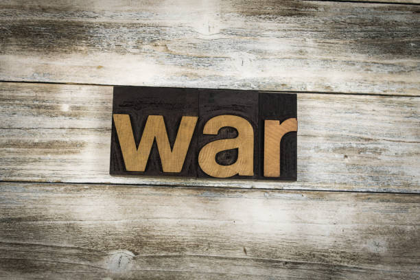 Abstract composition of war. Isolated wooden letters and red glass ball.