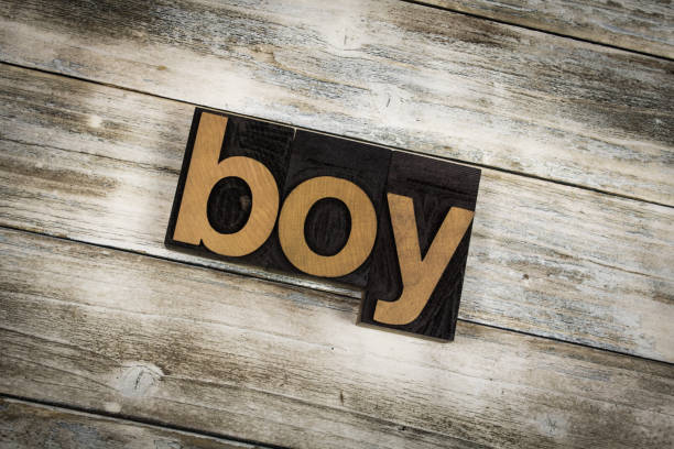 istock Boy Letterpress Word on Wooden Background 696924558