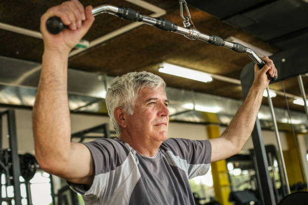 istock Active senior man working exercise in the gym. Man workout in gym. 696927378