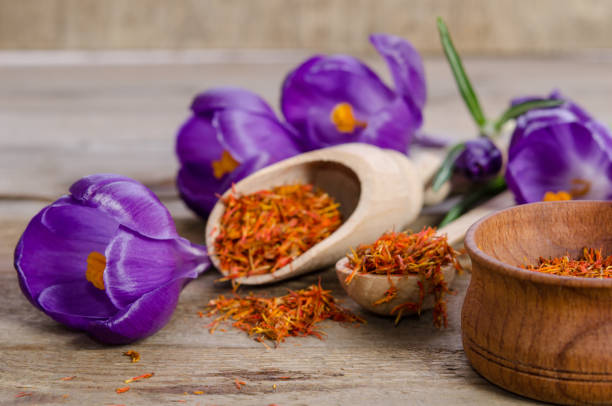 istock crocus flowers and spoon with soffron  on wooden table 696927464