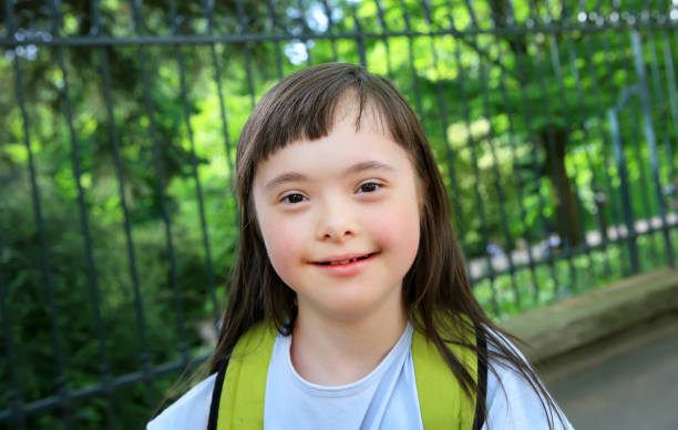 istock Down syndrome girl in the park 696927608