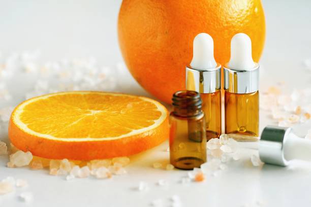 Cosmetic brown bottle containers with fresh orange slices, Blank label for branding mock-up, Natural Vitamin C beauty product concept. Cosmetic brown bottle containers with fresh orange slices, Blank label for branding mock-up, Natural Vitamin C beauty product concept. (Selective Focus) oranges with faces stock pictures, royalty-free photos & images