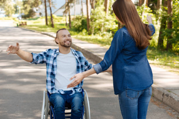istock Positive delighted disabled man going to hug his friend 696928442