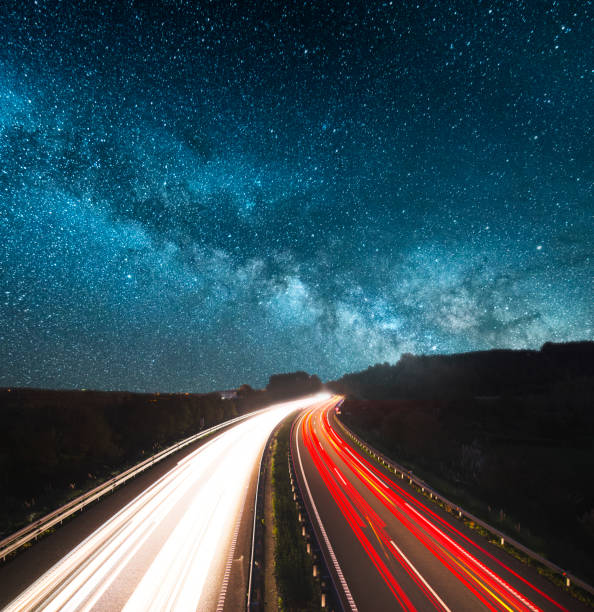 Highway at night A highway at night under the milky way car street blue night stock pictures, royalty-free photos & images