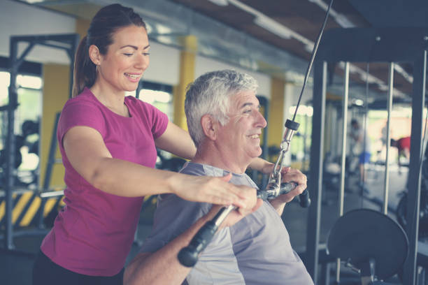 istock Personal trainer working exercise with senior man in the gym. 696931470