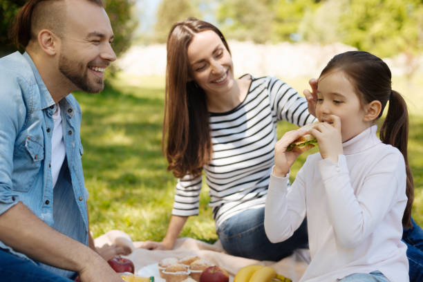 istock Attentive girl while eating tasty sandwich 696932304