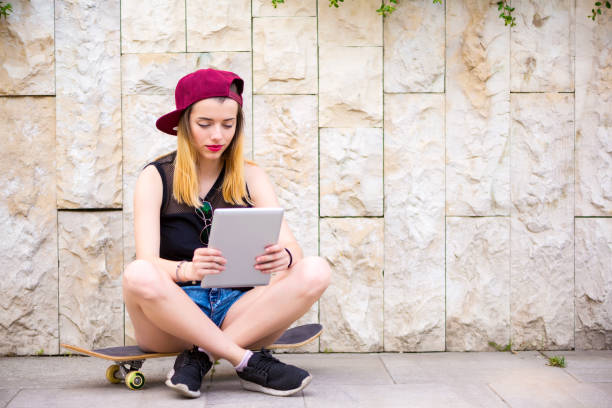 istock Teenage girl using a tablet watching media content 696935570