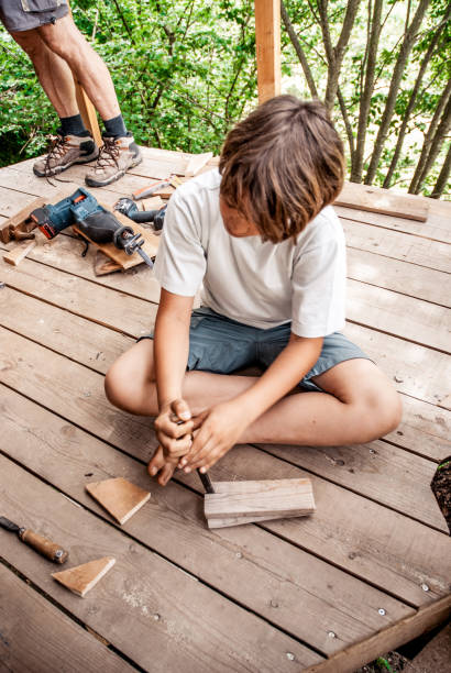 istock Father and Son Building a Tree House Together 696935612