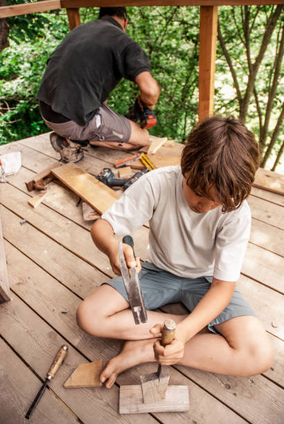 istock Father and Son Building a Tree House Together 696935878