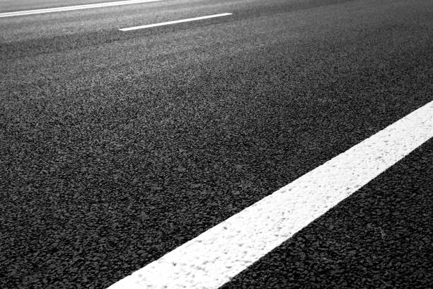 istock Asphalt road with marking lines white stripes 696935960