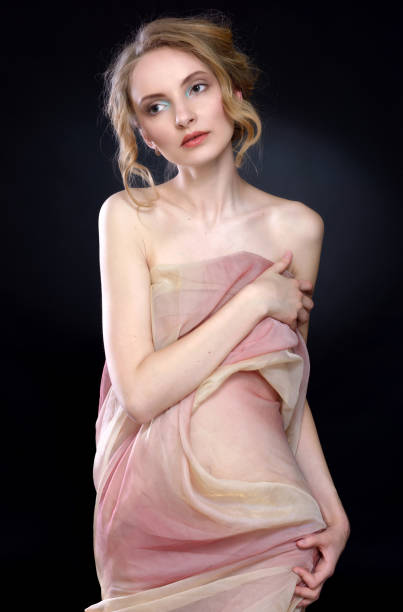 beautiful woman draped in transparent dress. stock photo