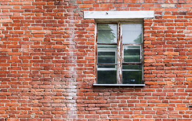 istock Window with wooden frame in old brick wall 696938700