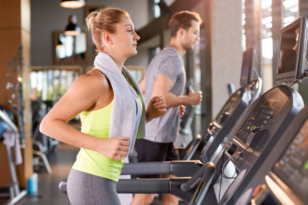 istock Healthy Woman Running on Treadmill 696944450
