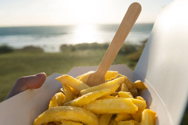 istock Box of Chips at the seaside. 696947746