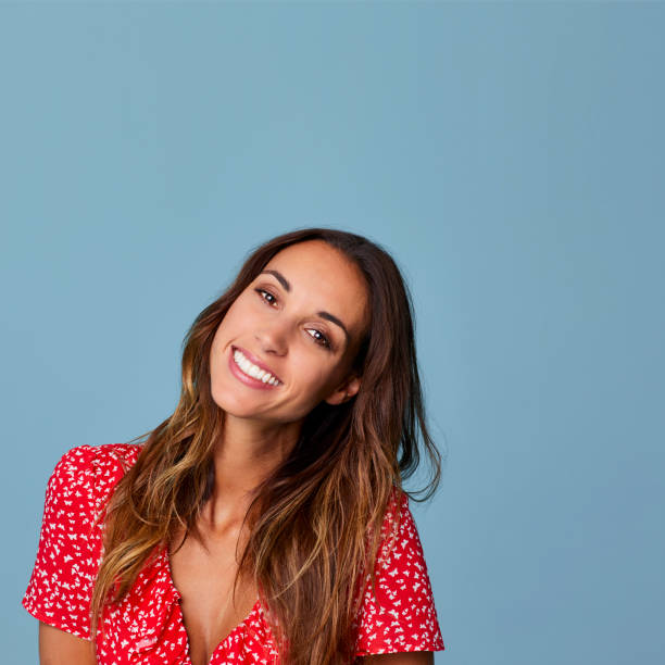 istock Smiling beautiful woman with head cocked 696948620