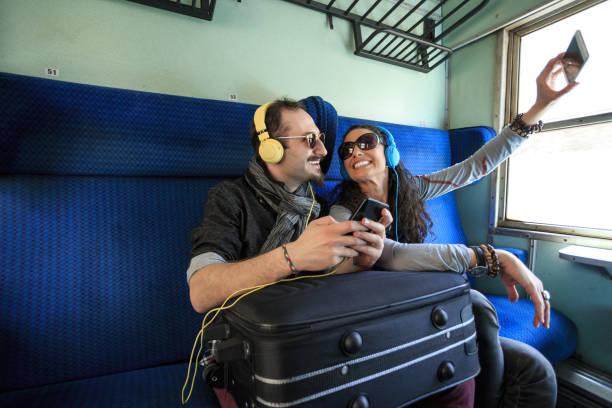 istock Couple tourists taking selfie in train 696949576